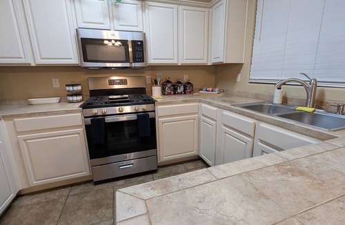 Bell West Ranch House | Cozy Surprise Desert Oasis Kitchen & 4 Bedrooms w/AC. Group & Pet-Friendly!