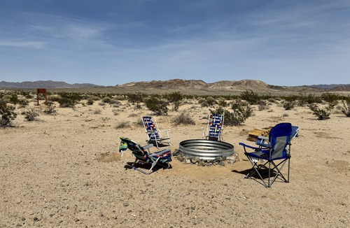 Wonder Valley RV Rental | RV space with fire pit under the stars