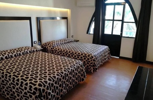 Mazatlan Hotel | Seaside Retreat: Comfortable Room with Clean Beds and Panoramic Ocean Views